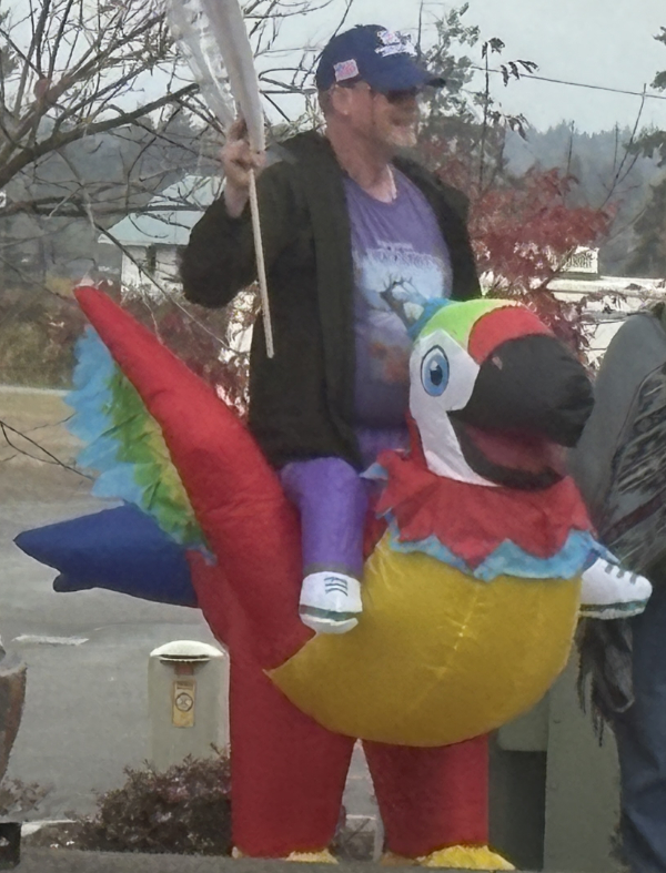 Man riding a blow up parrot